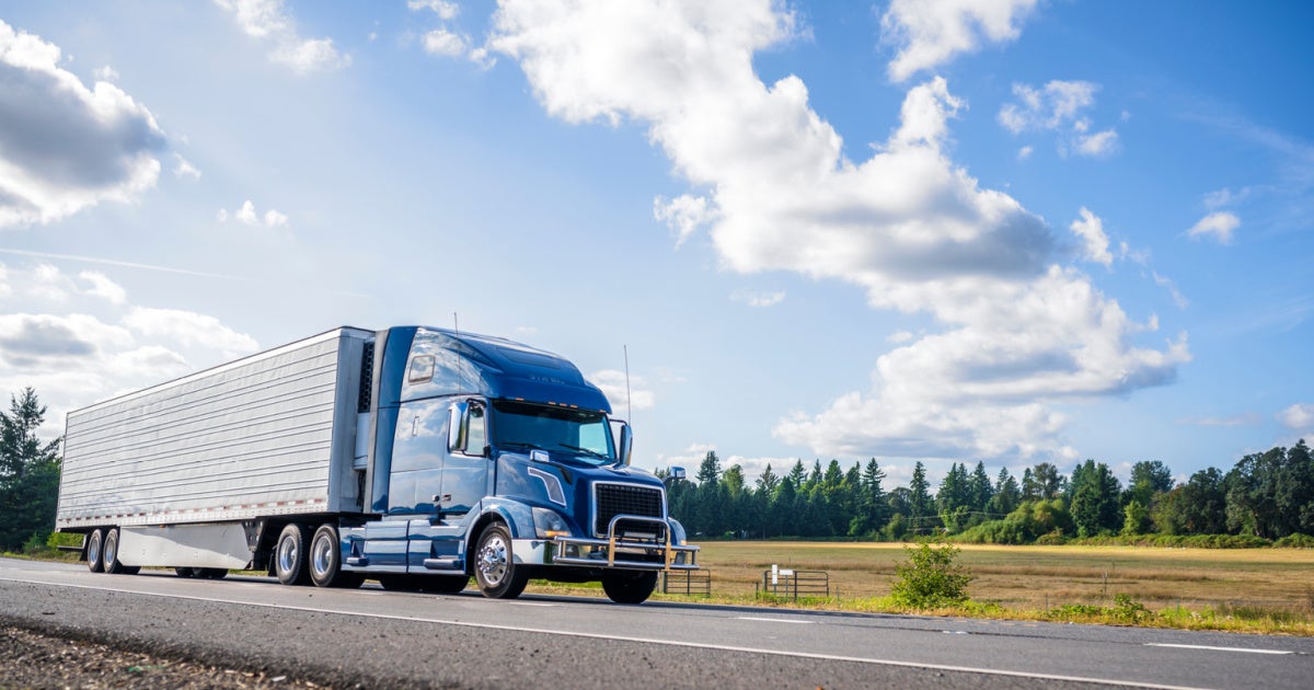 Blue truck driving on road